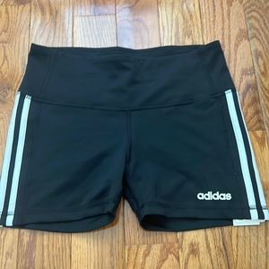 Black adidas athletic shorts with white strips. Size medium and BRAND NEW (tag)